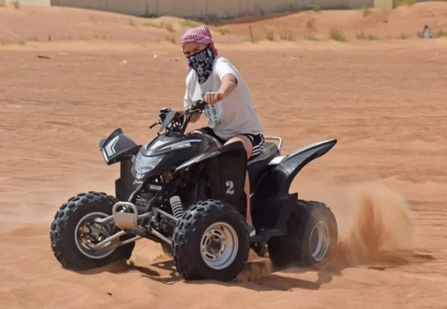 Yamaha 220cc beginner quad bike parked on Dubai desert sand